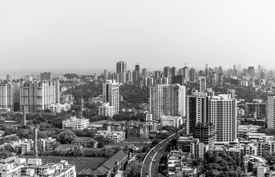 High angle view of modern buildings in city against clear sky