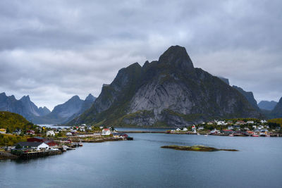 Scenic view of sea and mountains against sky