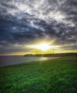 Scenic view of field against sky during sunset