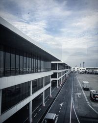 Road leading towards city against sky