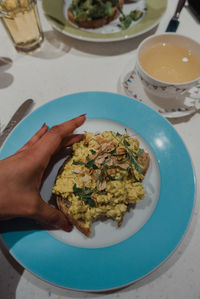 High angle view of woman holding food in plate