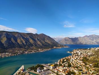 Scenic view of lake and mountains against blue sky
