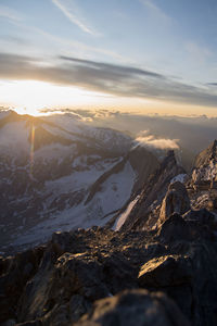 Aerial view of snowcapped mountains against sky during sunset