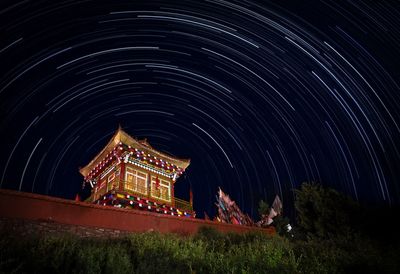 Illuminated temple against sky at night