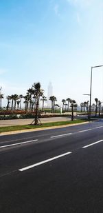 Empty road against sky in city