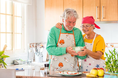 Senior couple preparing food at home