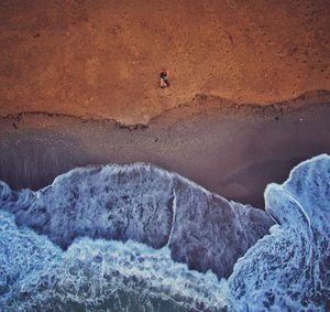 High angle view of man on rock formation in desert