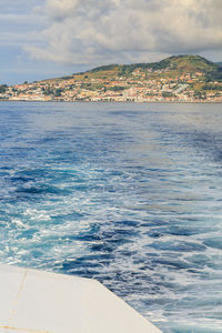 Scenic view of sea against sky in city