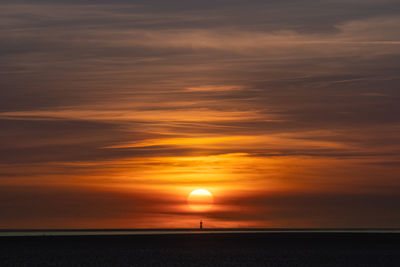 Scenic view of sea against orange sky