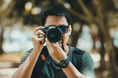 Portrait of young man photographing