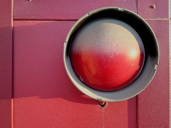 Close-up of red light mounted on wall