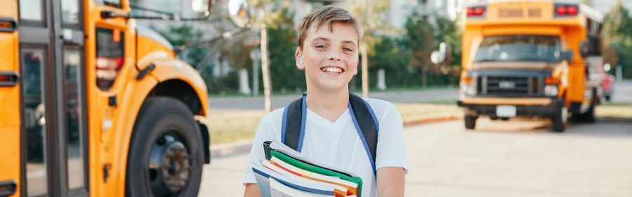 Portrait of smiling boy in city