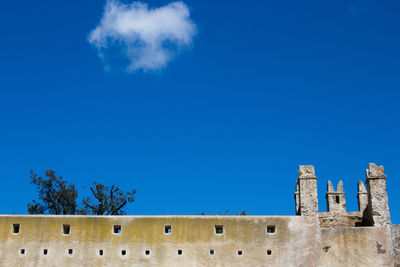 Low angle view of fort against blue sky