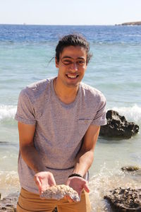 Portrait of smiling young man on beach
