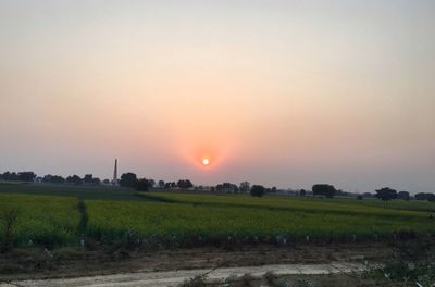 Scenic view of field against sky during sunset