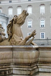 Statue against building