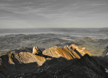 Mountain range in the autumn sunlight against overcast sky