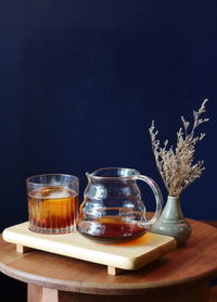 Close-up of tea cup on table against black background