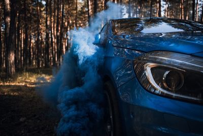 Close-up of blue car on land