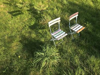 High angle view of empty chair on field