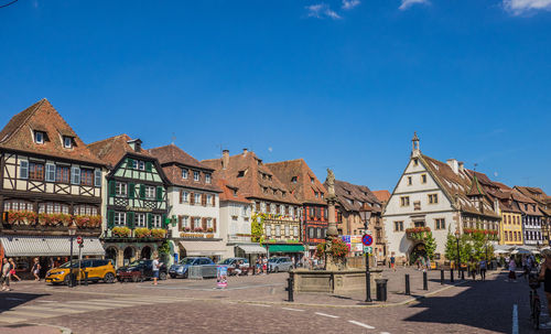 Buildings in city against blue sky, marketplace