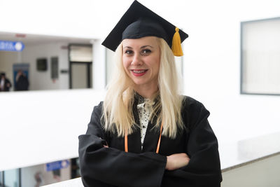 Midsection of woman wearing graduation gown