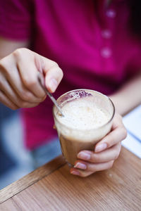 The girl has a cup of delicious latte