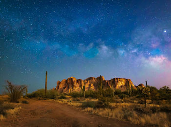 Scenic view of field against sky at night