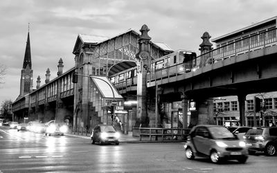 Cars on street against sky