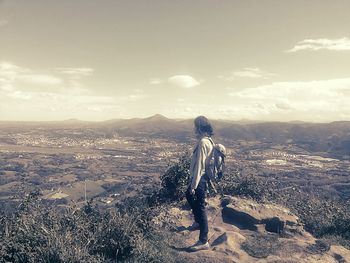 Rear view of man with cityscape in background