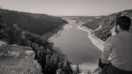 Panoramic view of man standing by mountain against sky