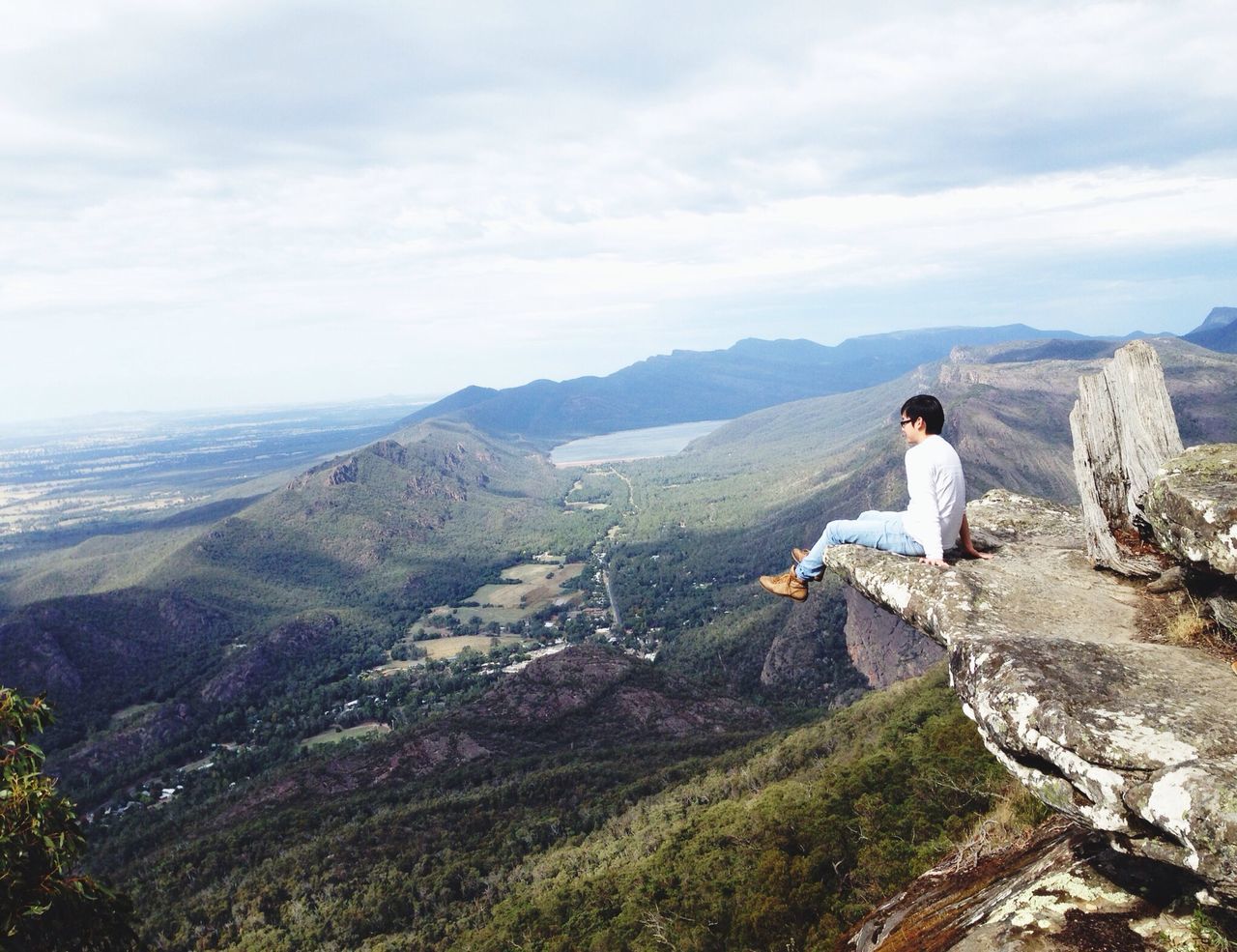 mountain, sky, tranquil scene, leisure activity, lifestyles, landscape, scenics, tranquility, beauty in nature, mountain range, nature, cloud - sky, rear view, full length, casual clothing, looking at view, standing, rock - object