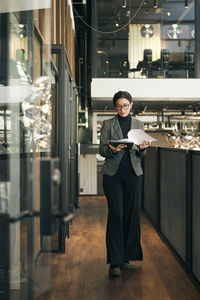 Portrait of young woman standing in city