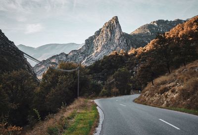 Road amidst mountains against sky