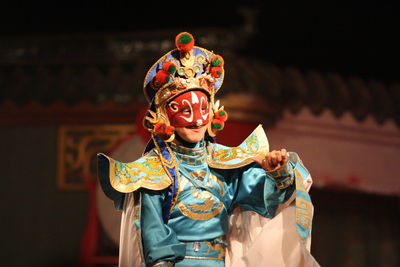 Close-up of woman in costume standing on stage