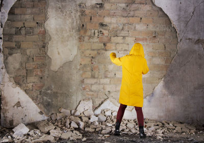 Rear view of silhouette woman walking in tunnel