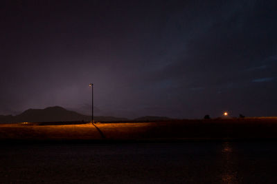 Scenic view of landscape against sky at night