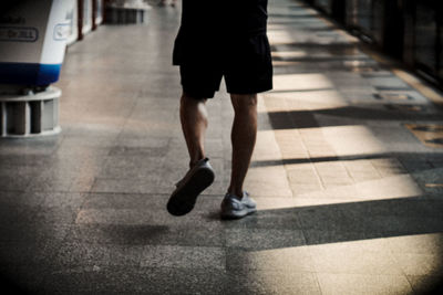 Low section of man walking on footpath