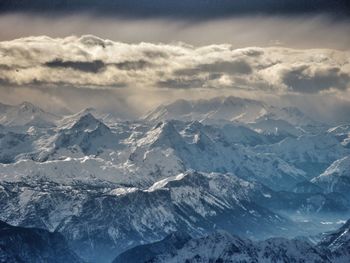 Scenic view of mountains against cloudy sky