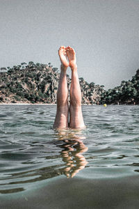 Low section of man relaxing in water