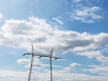 Low angle view of electricity pylon against sky