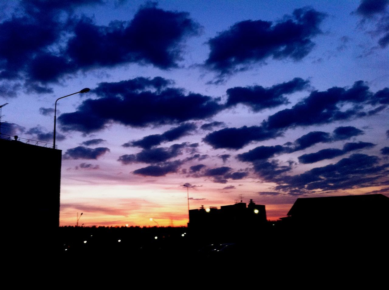 silhouette, building exterior, sunset, architecture, built structure, sky, cloud - sky, dramatic sky, city, house, low angle view, dusk, orange color, dark, residential structure, building, cloudy, cloud, residential building, outdoors