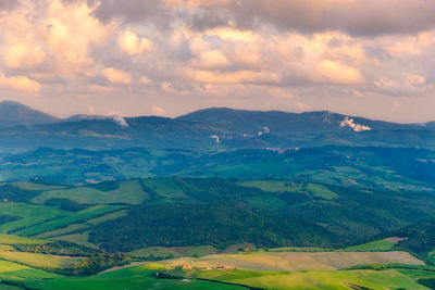 Scenic view of landscape against cloudy sky