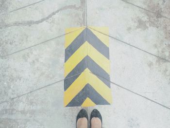 Low section of woman standing on street