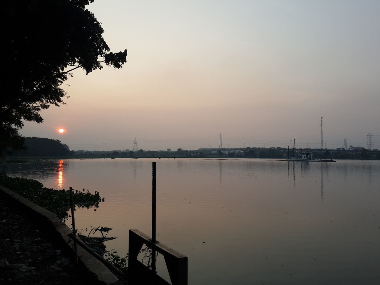 water, sunset, reflection, silhouette, clear sky, sea, tranquility, tranquil scene, sky, built structure, copy space, sun, scenics, nature, beauty in nature, river, lake, dusk, architecture, pier