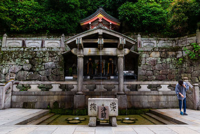 People outside temple against building