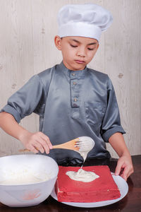 Boy preparing food in kitchen