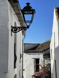 Low angle view of street light against building