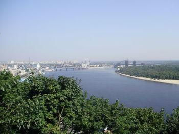 High angle view of river by city against clear sky