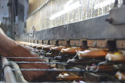 Cropped image of hand working on weaving machine